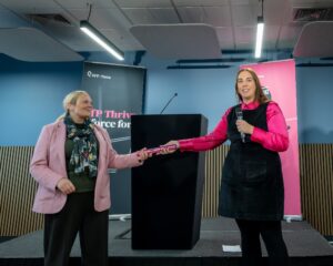 Left, Zoe Ferris Head of Organisational Development and Engagement at Amplius, accepts the baton from PfP Thrive's head of partnerships Jen Radcliffe